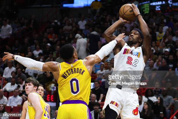 Jimmy Butler of the Miami Heat shoots over Russell Westbrook of the Los Angeles Lakers during the first quarter of the game at FTX Arena on December...