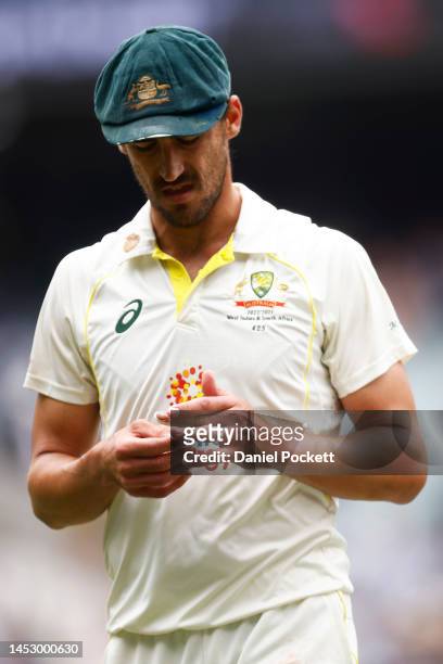Mitchell Starc of Australia checks his injured finger during day four of the Second Test match in the series between Australia and South Africa at...