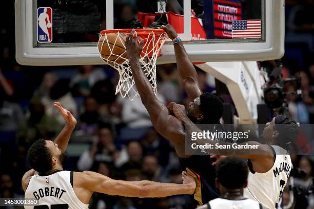Zion Williamson of the New Orleans Pelicans dunks over Jaden McDaniels of the Minnesota Timberwolves during the second quarter of an NBA game at...