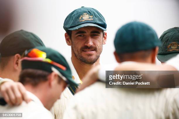 Mitchell Starc of Australia looks on in the team huddle during day four of the Second Test match in the series between Australia and South Africa at...
