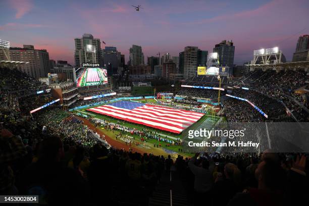Members of the Navy unfurl a large American flag prior to a game between the North Carolina Tar Heels and the Oregon Ducks in the San Diego Credit...