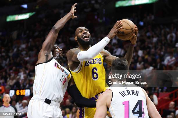 LeBron James of the Los Angeles Lakers goes to the basket against Bam Adebayo and Tyler Herro of the Miami Heat during the fourth quarter of the game...