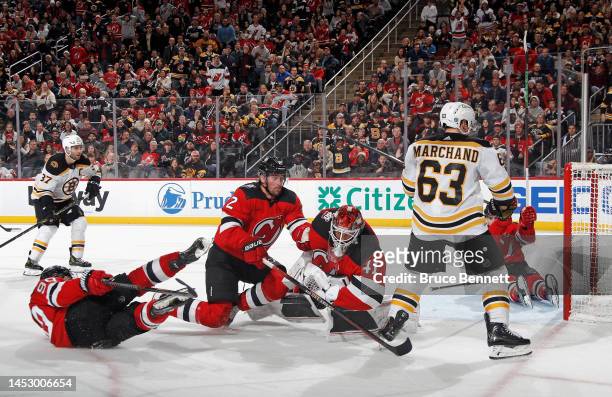 The New Jersey Devils scramble following a save by Vitek Vanecek against the Boston Bruins during the third period at the Prudential Center on...