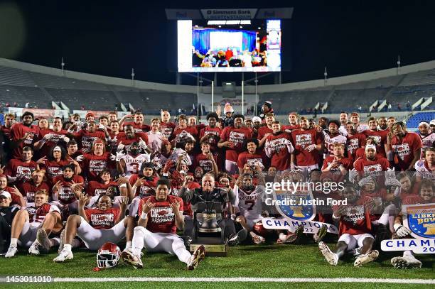 The Arkansas Razorbacks team pose for a photo after defeating the Kansas Jayhawks to win the Autozone Liberty Bowl at Simmons Bank Liberty Stadium on...