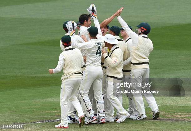 Mitchell Starc of Australia is congratulated by team mates after running out of Keshav Maharaj of South Africa during day four of the Second Test...