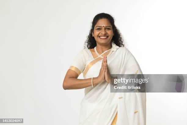 south indian woman greeting in prayer pose - sari isolated stock pictures, royalty-free photos & images