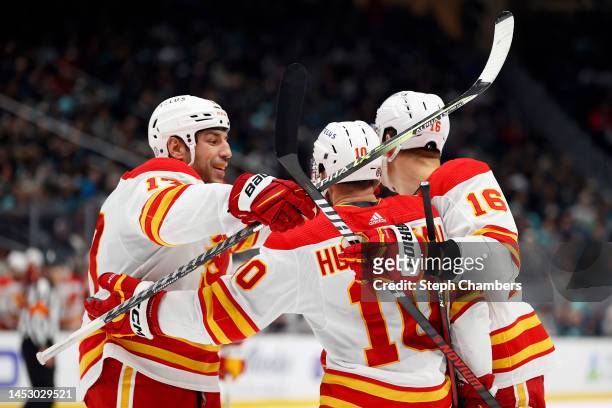 Jonathan Huberdeau of the Calgary Flames celebrates his goal with Milan Lucic and Nikita Zadorov of the Calgary Flames during the third period...