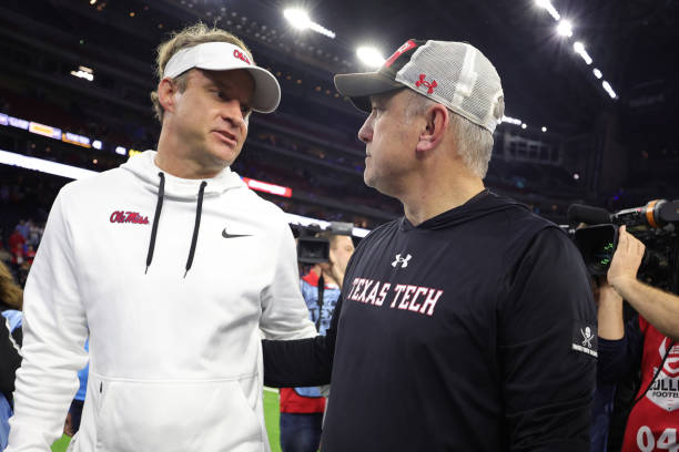 Head coach Joey McGuire of the Texas Tech Red Raiders and Head coach Lane Kiffin of the Mississippi Rebels shake hands at NRG Stadium on December 28,...