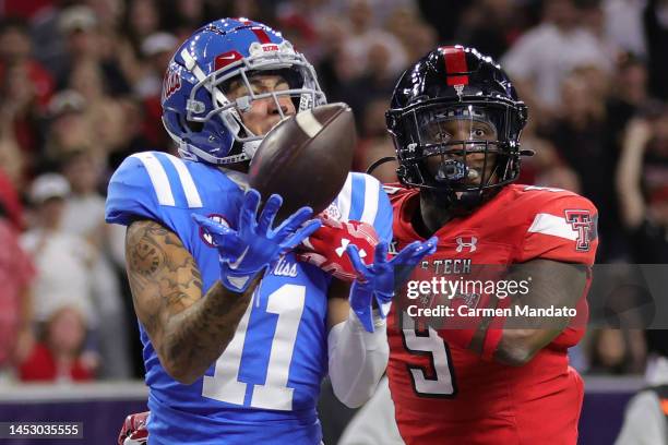 Jordan Watkins of the Mississippi Rebels reception for a touchdown ahead of Marquis Waters of the Texas Tech Red Raiders during the second half at...