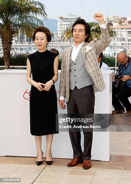 Actors Youn Yuh-jung and Baek Yoon-sik pose at the 'Do-nui Mat' photocall during the 65th Annual Cannes Film Festival at Palais des Festivals on May...