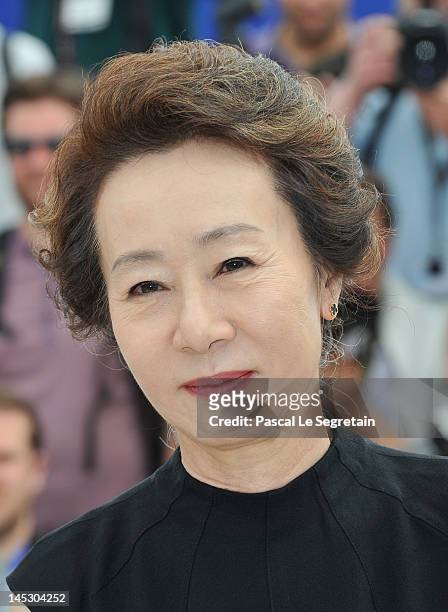 Actress Youn Yuh-jung pose at the 'Do-nui Mat' photocall during the 65th Annual Cannes Film Festival at Palais des Festivals on May 26, 2012 in...