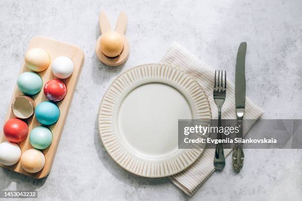 easter table setting with egg's nest, plate and cutlery. - easter dinner stock pictures, royalty-free photos & images