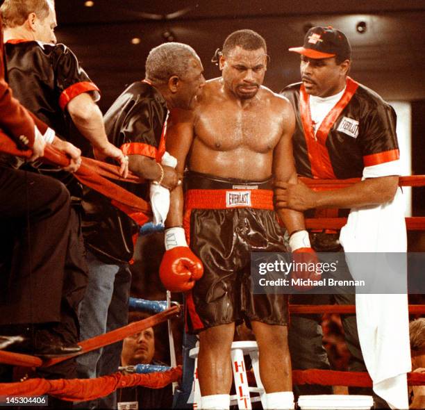 American Heavyweight boxer Oliver McCall is flanked by his trainers George Benton and Greg Page as he heads for the fourth round against Lennox Lewis...