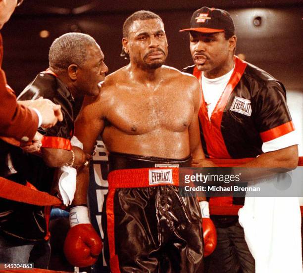 American Heavyweight boxer Oliver McCall is flanked by his trainers George Benton and Greg Page as he heads for the fourth round against Lennox Lewis...