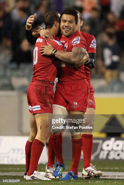 Quade Cooper and Digby Ioane of the Reds celebrate after winning the round 14 Super Rugby match between the Brumbies and the Reds at Canberra Stadium...