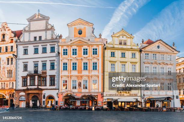 multicolored houses at the old town square in prague, czech republic - prag stock-fotos und bilder