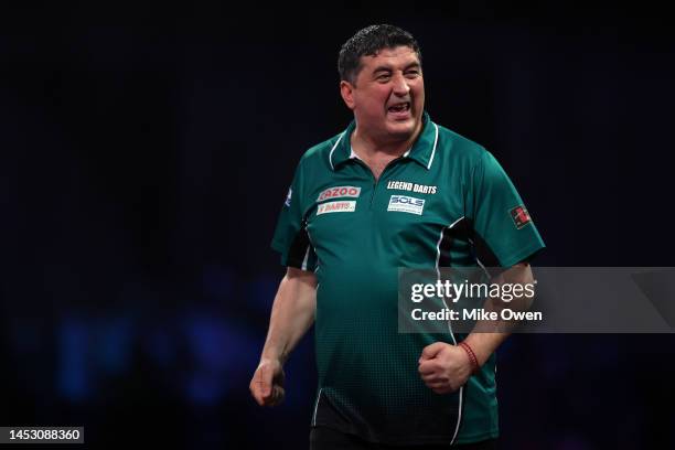 Mensur Suljovic of Serbia celebrates during his Third Round match against Michael van Gerwen of Netherlands during Day Nine of The Cazoo World Darts...