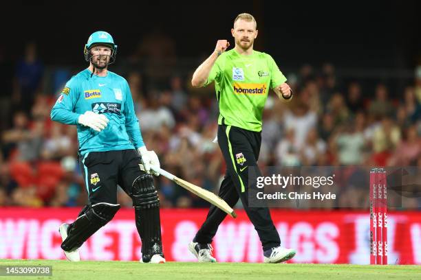 Nathan McAndrew of the Thunder celebrates dismissing Colin Munro of the Heat during the Men's Big Bash League match between the Brisbane Heat and the...