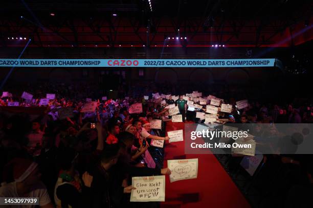 Mensur Suljovic of Serbia walks out during his Third Round match against Michael van Gerwen of Netherlands during Day Nine of The Cazoo World Darts...