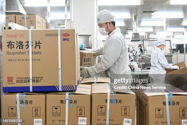 Employees work on the production line of ibuprofen, a fever reduction medicine, at BaiYunShan General Factory under Guangzhou Pharmaceutical Holdings...