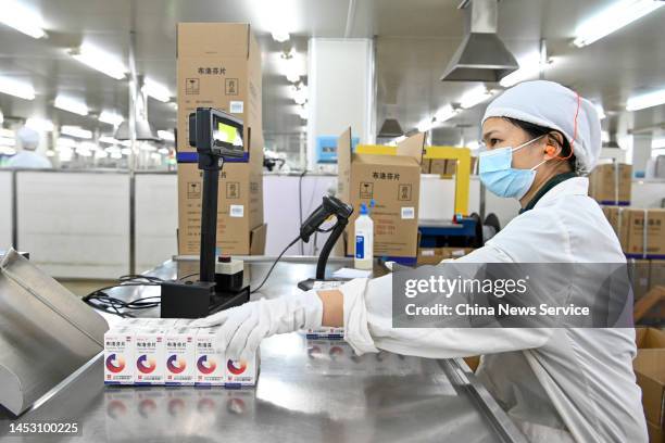 An employee works on the production line of ibuprofen, a fever reduction medicine, at BaiYunShan General Factory under Guangzhou Pharmaceutical...