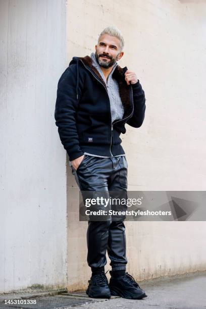 Singer Marc Terenzi, wearing a grey sweater with zipper by Superdry, a black sweat jeacket with brown teddy fur inside by Superdry, black leather...