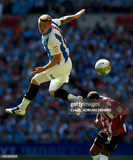 Huddersfield's Danny Ward competes for the ball against Sheffield United's Nick Montgomery during the League 1 Play-Off Final football match between...