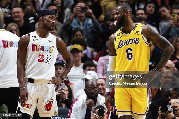 Jimmy Butler of the Miami Heat and LeBron James of the Los Angeles Lakers talk on the court during the third quarter of the game at FTX Arena on...