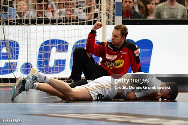 Kim Andersson of Kiel lies on the pitch during the EHF Final Four semi final match between Fuechse Berlin and THW Kiel at Lanxess Arena on May 26,...