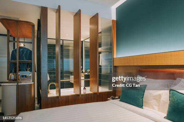 luxury hotel room with bathroom with bathtub, double bed and closet - hotel suite stock pictures, royalty-free photos & images