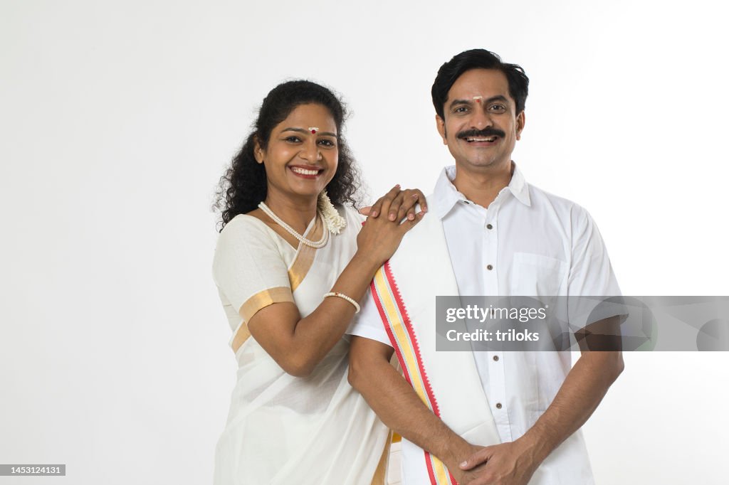 South Indian couple posing in traditional clothing