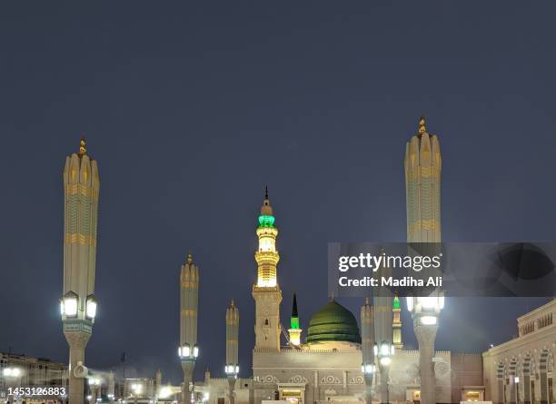 a view of umbrellas and minarets of prophet mosque at dawn in madinah, also known as masjid an nabwi | arches architecture design | rawdah rasool, riyadh ul jannah | prophet muhammad | saudi arabia - muhammad prophet stock pictures, royalty-free photos & images