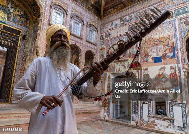 Musician playing sitar inside an old haveli courtyard, Rajasthan, Nawalgarh, India on November 6, 2022 in Nawalgarh, India.