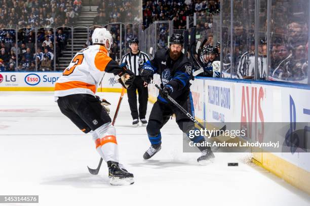 Jordie Benn of the Toronto Maple Leafs plays the puck against Kevin Hayes of the Philadelphia Flyers during the second period at the Scotiabank Arena...