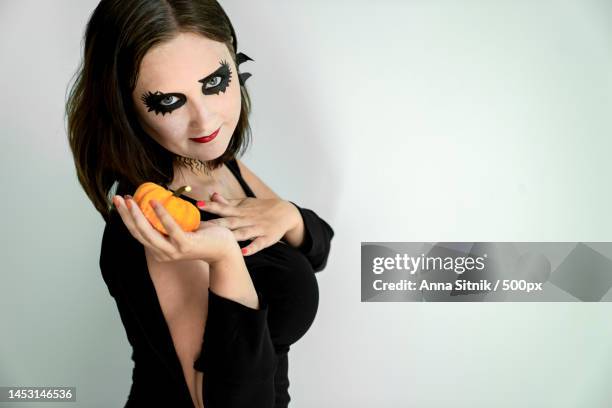 girl with halloween makeup on face holds pumpkin in hand,turkey - ugly black women ストックフォトと画像