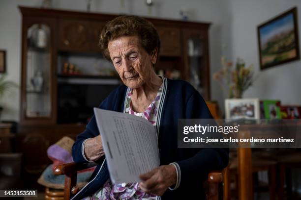 the elderly woman sat in her favorite armchair and pulled out her memory exercise book, determined to keep her mind sharp while enjoying the comfort of her home. - school exercise book cover stock pictures, royalty-free photos & images
