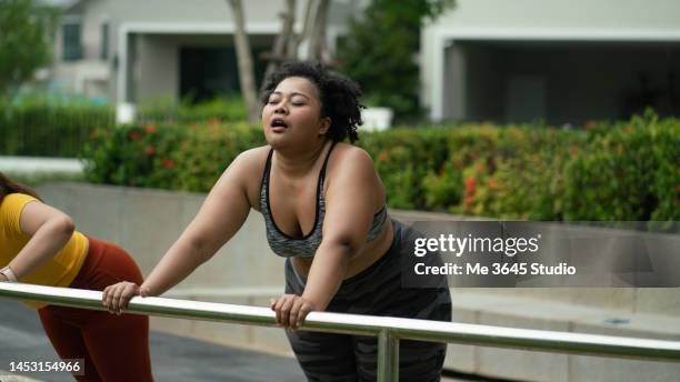 overweight woman exercising for good health - slightly overweight stock pictures, royalty-free photos & images