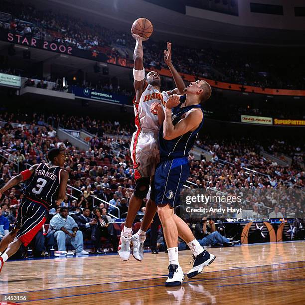 Shareef Abdur-Rahim of the Atlanta Hawks shoots against Dirk Nowitzki of the Dallas Mavericks during the 2002 NBA All Star Game at the First Union...