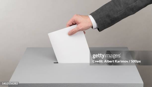 cropped hand of businessman holding blank visiting card against white background,uzbekistan - ballot box bildbanksfoton och bilder