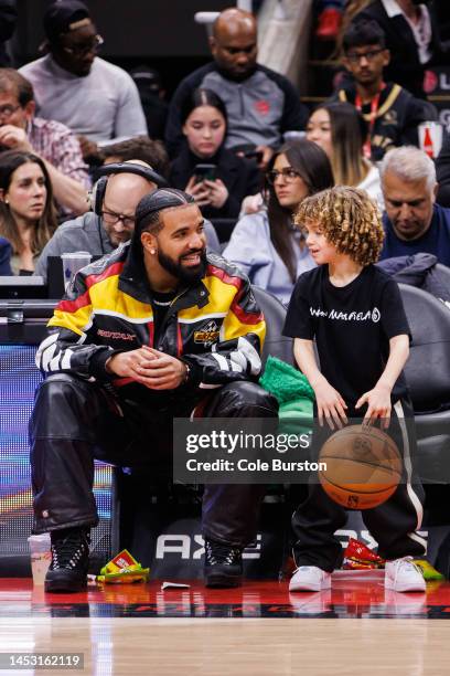 Rapper Drake plays with his son Adonis during the second half of the NBA game between the Toronto Raptors and the LA Clippers at Scotiabank Arena on...