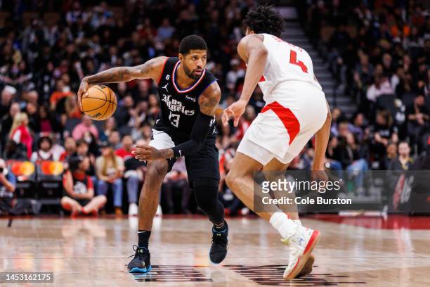 Paul George of the LA Clippers dribbles against Scottie Barnes of the Toronto Raptors during the second half of their NBA game at Scotiabank Arena on...
