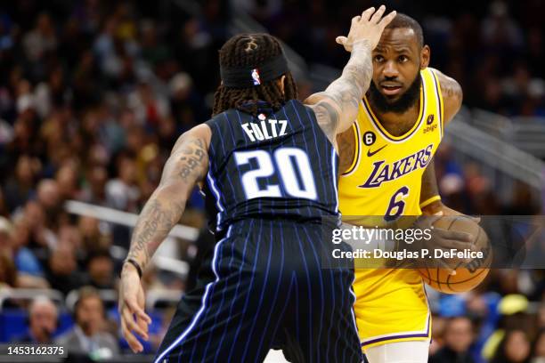 LeBron James of the Los Angeles Lakers handles the ball as Markelle Fultz of the Orlando Magic defends during the fourth quarter at Amway Center on...