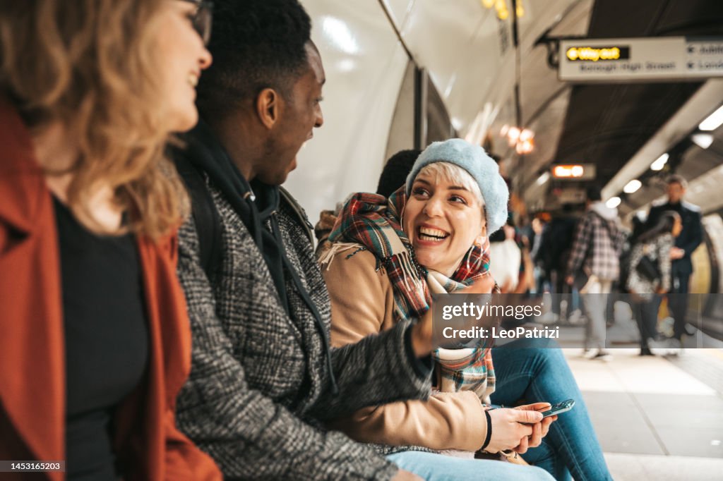 Group of multi ethnic friends moving by subway
