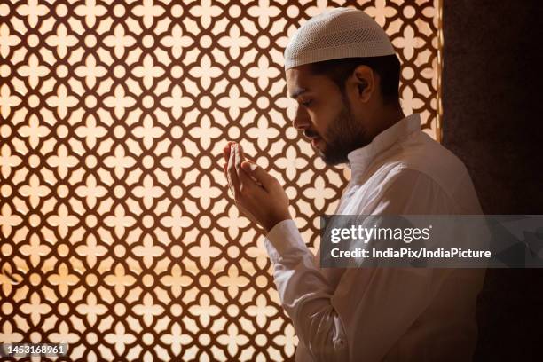 portrait of a muslim man praying at home - namaz stock-fotos und bilder