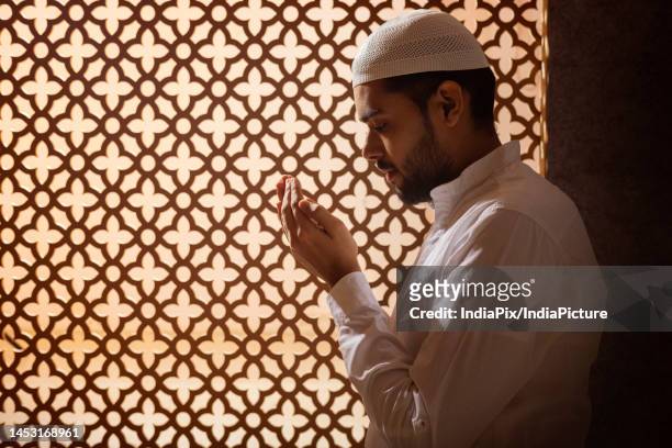 portrait of a muslim man praying at home - namaz stock pictures, royalty-free photos & images