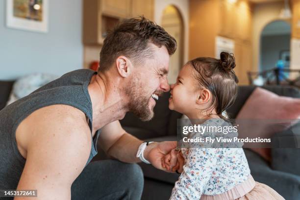 happy toddler girl playing with her dad - family at home stock pictures, royalty-free photos & images