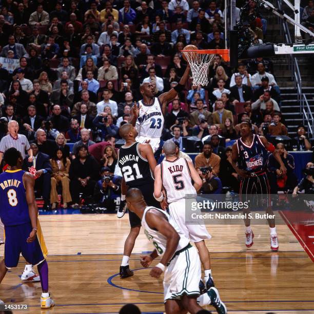 Michael Jordan of the Washington Wizards drives to the basket against Tim Duncan of the San Antonio Spurs during the 2002 NBA All Star Game at the...