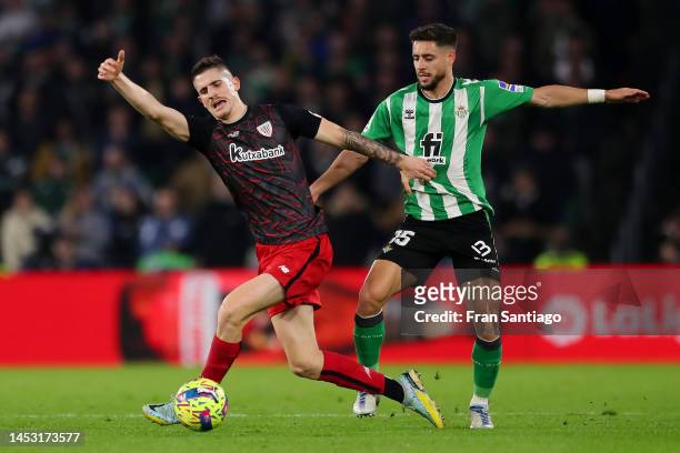 Oihan Sancet of Athletic Club is challenged by Alex Moreno of Real Betis during the LaLiga Santander match between Real Betis and Athletic Club at...