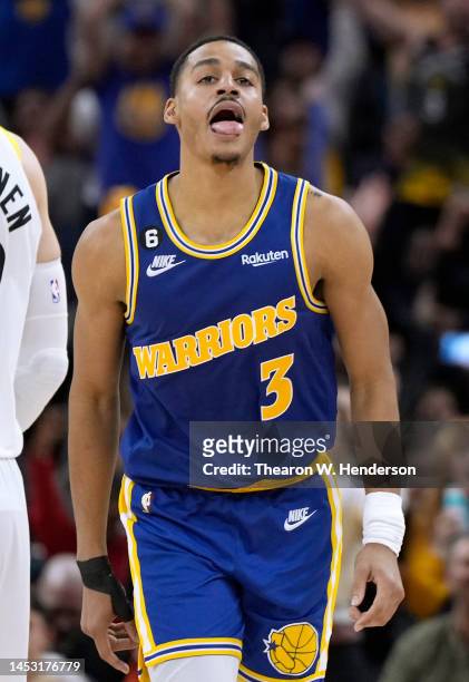 Jordan Poole of the Golden State Warriors reacts after making a three-point shot over Lauri Markkanen of the Utah Jazz during the fourth quarter at...