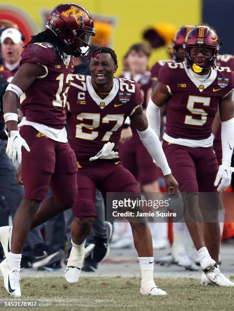Defensive back Tyler Nubin of the Minnesota Golden Gophers celebrates with defensive back Darius Green after Green made a stop on 4th down during the...